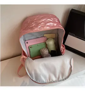 Detailed interior view of a pink quilted backpack showing large storage space and capacity