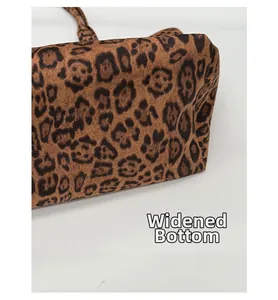 Detail showing the widened bottom base of the leopard print bucket tote bag