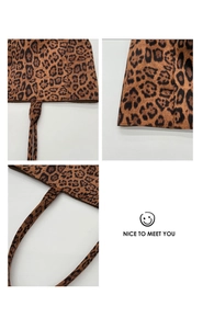 Macro shot of leopard print tote bag detailing corner stitching and material texture