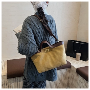 Détail d'un sac cabas vintage en cuir matelassé avec fermoir rotatif doré et bandoulière double