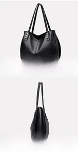Detail view of black pebbled leather tote bag with silver metal handle connectors