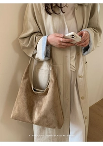 Detail shot of the khaki suede texture and spacious interior of the retro hobo tote bag