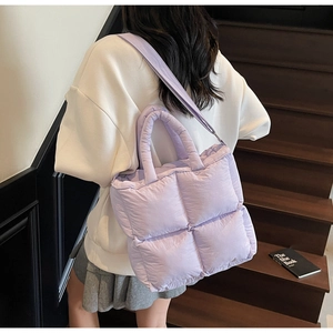 Detailed shot of lavender quilted puffer tote bag featuring soft padded grid pattern textures