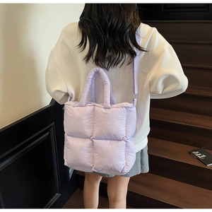 Detailed view of lavender quilted puffy tote bag featuring adjustable strap and padded handles