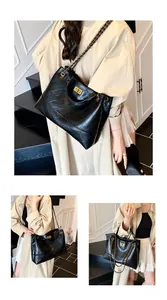 Detailed view of the luxury black quilted tote bag with chain strap and metal turn-lock