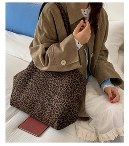 Macro shot of high-capacity leopard print tote bag with soft suede texture and wide strap