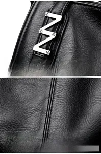 Close-up of litchi texture black leather handbag with metal V-buckle and reinforced stitching