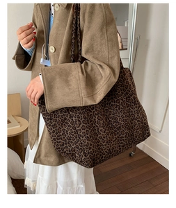 Detailed view of oversized leopard print tote bag fabric and spacious bucket design