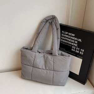 Chic grey quilted tote bag with padded diamond stitching for women's winter fashion