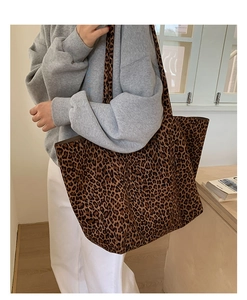 Macro detail of large leopard print tote bag fabric and spacious bucket design