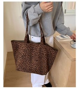 Detail shot of a large leopard print tote bag with soft fabric and double shoulder straps