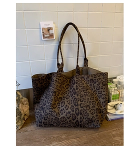 Close-up of a large leopard print tote bag made of thick canvas fabric for daily commute