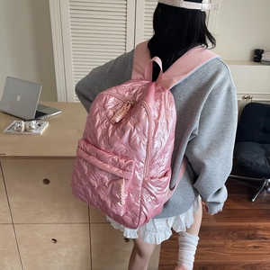 Pink quilted nylon backpack with butterfly embossing and a large front pocket
