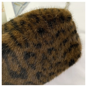 Close-up of soft plush leopard print faux fur texture on a fashion chain crossbody bag