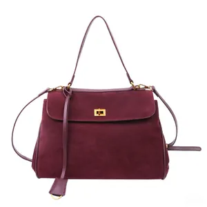 Detail of burgundy matte faux suede handbag with premium gold twist lock closure and handle