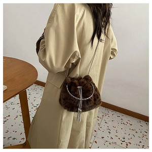 Leopard print faux fur bucket bag with silver metal ring handle and tassel details