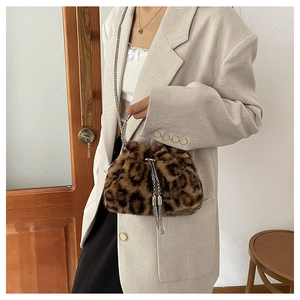 Detail of plush leopard print bucket bag with silver chain strap and drawstring closure