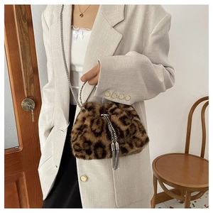 Close-up of leopard print plush bucket bag with silver chain strap and tassel drawstring