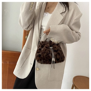 Close-up of leopard print faux fur bucket bag with silver metal chain and tassels