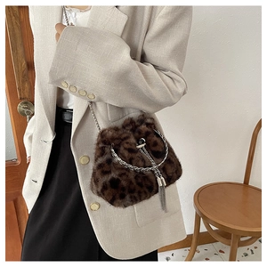 Fashionable leopard print faux fur bucket bag with silver metal chain and tassel detail
