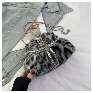 Detail of leopard print faux fur bucket bag with rhinestone tassels and silver chain