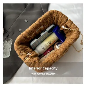 Macro view of brown knit bag interior showing capacity for smartphone and cosmetics