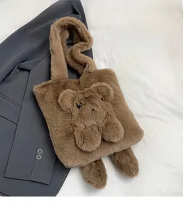 Detailed shot of brown plush teddy bear handbag on a grey blazer and white background