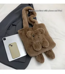 Detail of plush brown teddy bear tote bag showing size scale with tablet and phone