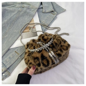 Detail of leopard print faux fur bucket bag with sparkling crystal trim and silver chain strap