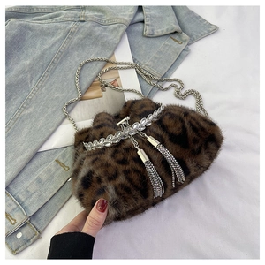 Detail of leopard print faux fur bag with rhinestone metal trim and silver tassels