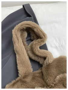 Detailed macro view of the soft brown faux fur texture and wide plush shoulder strap