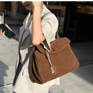 Retro dark brown frosted leather tote bag with metal lock shown on a model