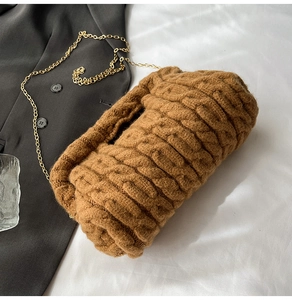 Detailed texture of brown thick knit chain bag with spiral weave pattern and gold strap