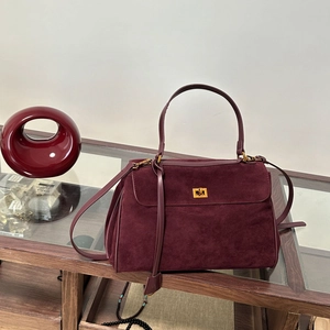 Vintage burgundy suede crossbody bag with elegant gold twist lock and single handle strap