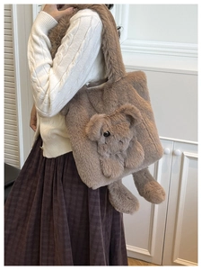 Detail of plush brown teddy bear shoulder bag featuring 3D fuzzy bear cub decorations