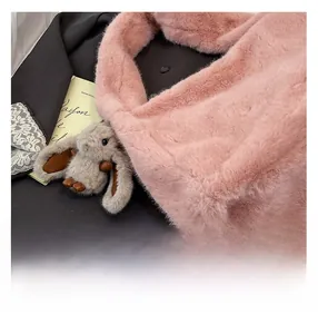 Detailed close-up of soft pink faux fur tote bag texture with cute bunny charm accessory