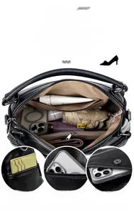 Detail view of large black lychee leather handbag with multiple pockets and compartments