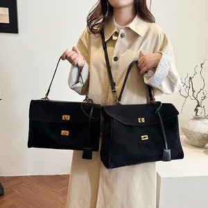 Détails de sacs cabas en daim noir en deux tailles avec fermoirs métalliques dorés