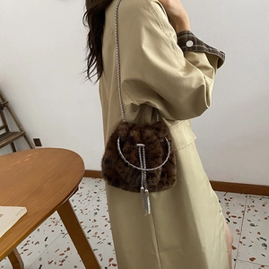 Deep brown faux fur bucket bag with leopard texture and silver chain strap for women