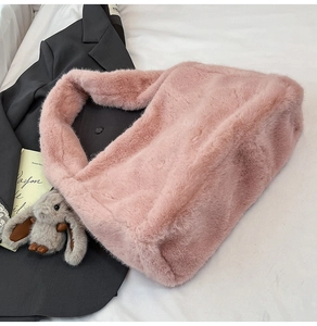 Close-up of pink faux fur shoulder bag with soft plush texture and cute bunny charm