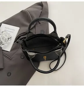 Top view of black lychee grain leather bucket bag showing internal zipper compartments