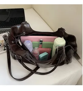 Interior shot showing the large capacity of a dark brown patent leather tote bag