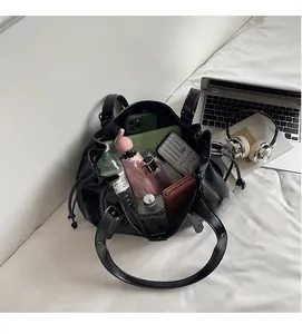 Top-down view of large capacity black tote bag showing spacious interior with personal items