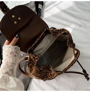 Interior detail of leopard print backpack showing drawstring closure and chevron lining