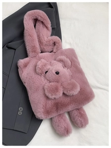 Close-up of pink plush teddy bear handbag with soft faux fur texture and 3D design