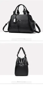 Detailed side view of black pebbled leather Boston bag with dual handles and silver hardware