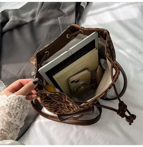 Spacious leopard print bucket bag interior showing capacity for tablet and daily items