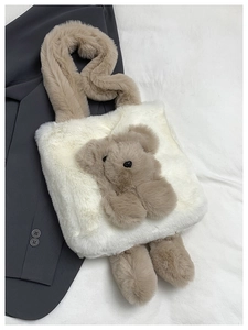 Detail of cream plush tote bag featuring a 3D teddy bear and soft faux fur handle