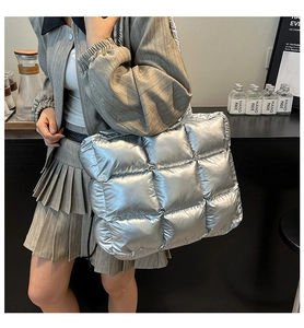 Silver quilted down tote bag worn by model for large capacity fashion commuting