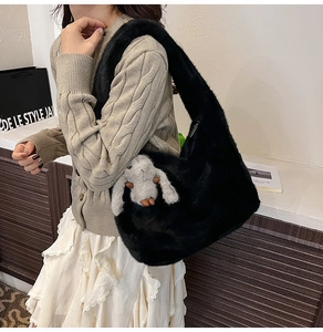 Detail of black faux fur hobo bag with soft plush texture and cute grey bunny keychain